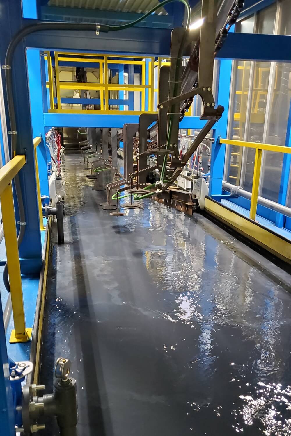 Racked products moving through the electrocoat line